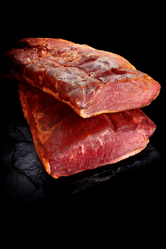 Pasture-raised Lomo Ibérico pork loin, showcasing its rich marbling and deep color, perfect for a variety of culinary uses.