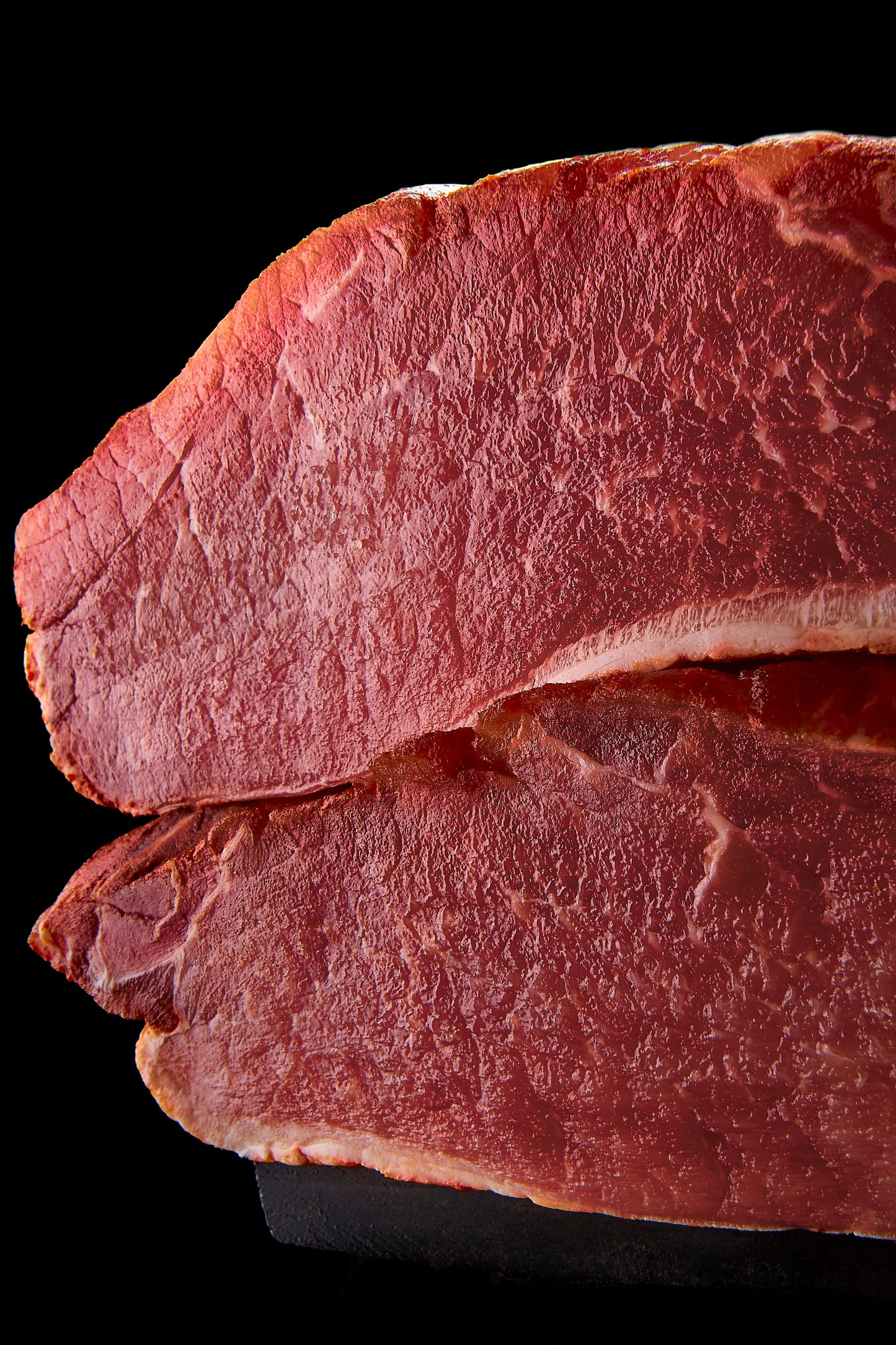 Pasture-raised Iberico pork loin with rich marbling, showcasing its deep red color and premium quality.