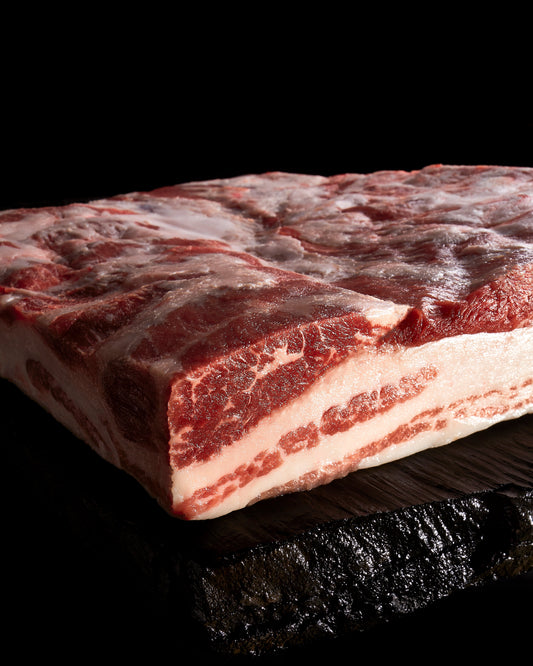 Richly marbled Panceta Ibérica Pork Belly, showcasing creamy white fat and premium quality from Spanish Iberico pigs.